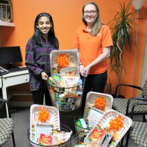 Margaux and Sami with Thanksgiving baskets.