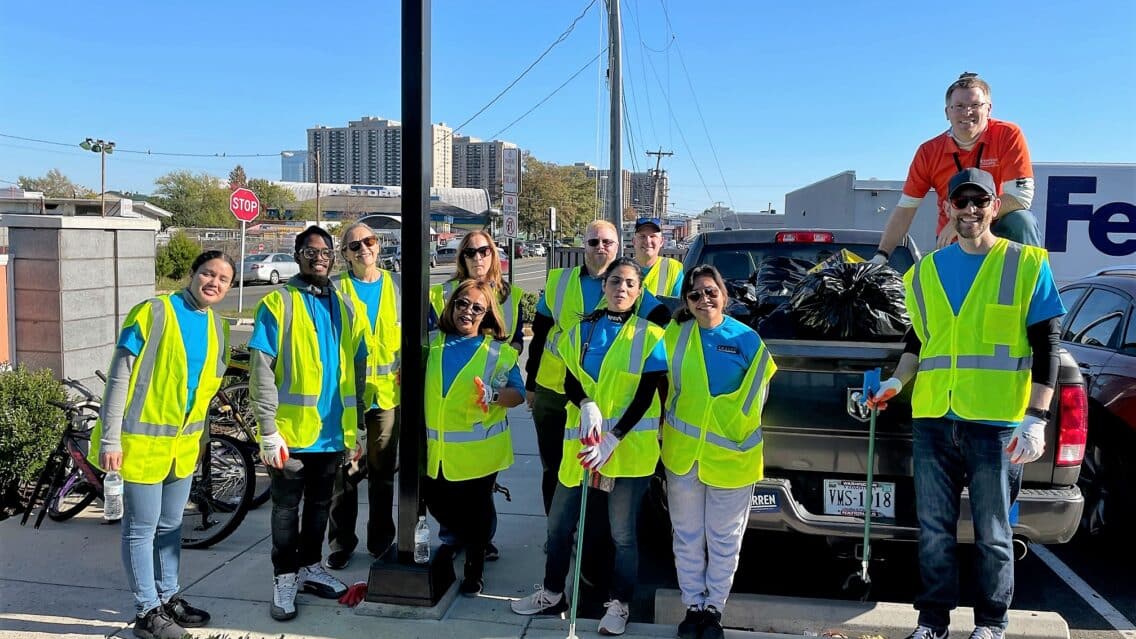 Volunteers from Hilton Crystal City gather in their reflective safety vests after picking up trash.