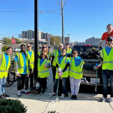 Volunteers from Hilton Crystal City gather in their reflective safety vests after picking up trash.
