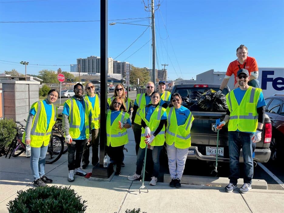 Volunteers from Hilton Crystal City gather in their reflective safety vests after picking up trash.